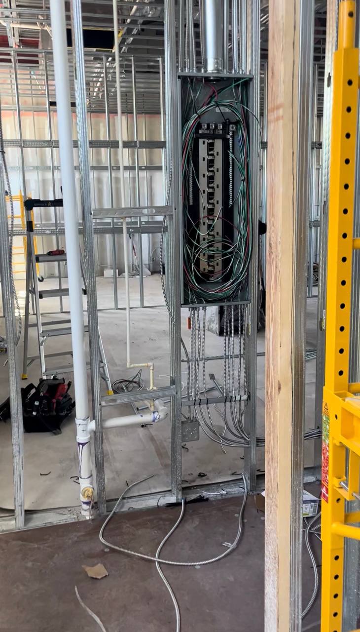 Electrical infrastructure being installed inside a commercial frame-out
