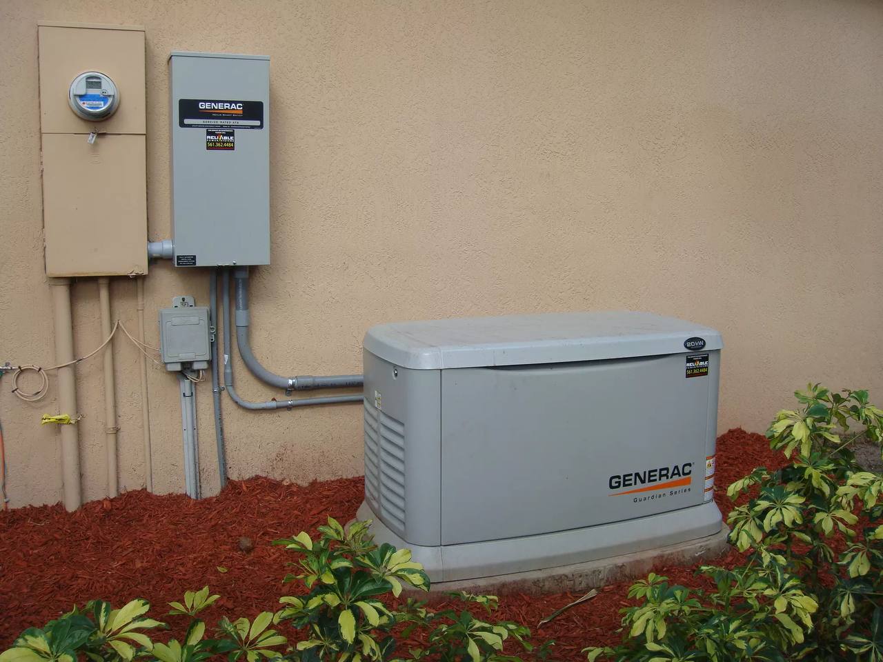 Completed Generac generator installed outside a property with transfer equipment nearby